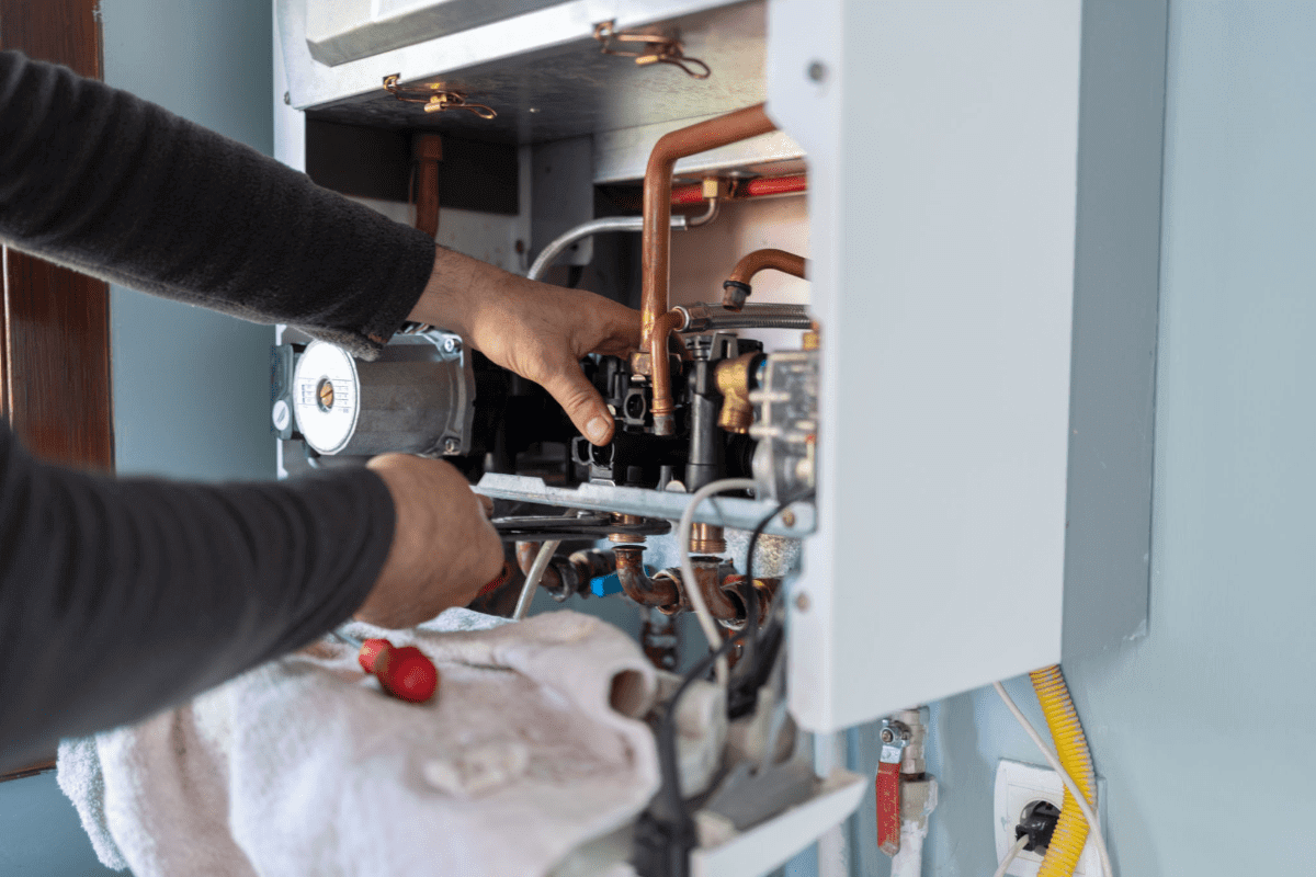 Person repairing a household gas boiler.